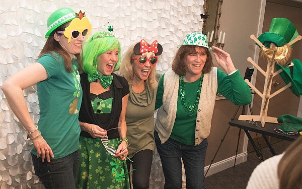 People dressed in green in the photo booth